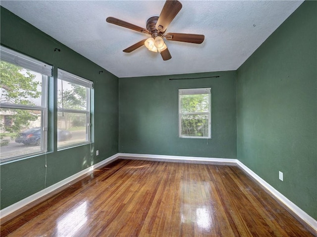 1809 Merriman Ave, Corpus Christi, TX 78412 - empty room featuring ceiling fan, a wealth of natural light, wood finished floors, and baseboards