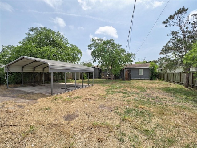1809 Merriman Ave, Corpus Christi, TX 78412 - view of yard with fence, driveway, and a detached carport