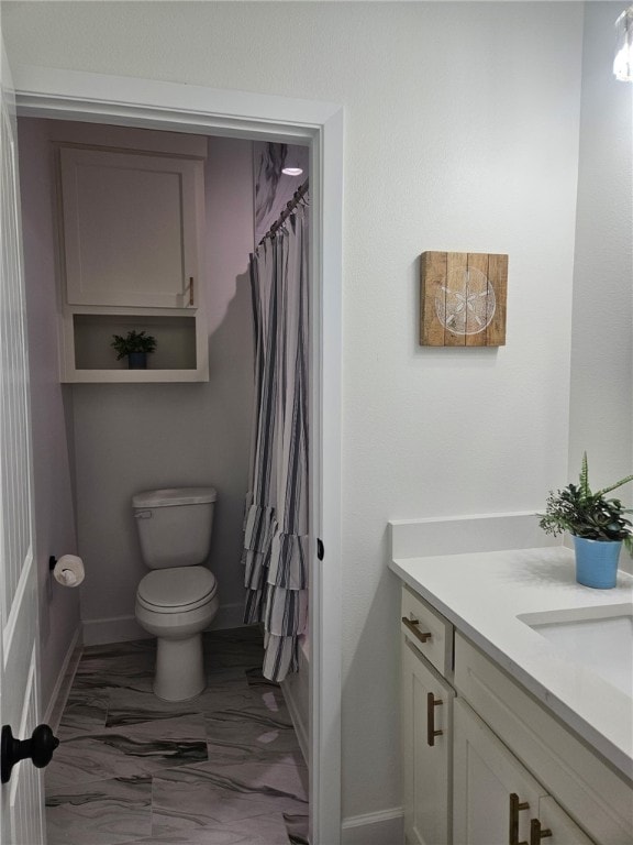 7713 Sophia Dr, Corpus Christi, TX 78414 - bathroom featuring toilet, baseboards, shower / bath combination, and marble finish floor