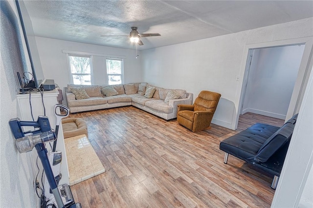 1309 Annapolis Dr, Corpus Christi, TX 78415 - living room with ceiling fan, light wood-type flooring, a textured ceiling, and baseboards