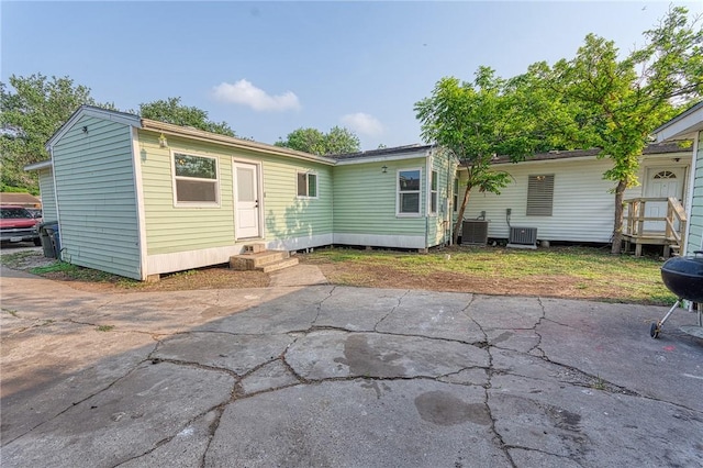 1309 Annapolis Dr, Corpus Christi, TX 78415 - back of property featuring entry steps, central AC unit, and a patio area