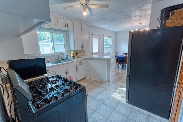 1309 Annapolis Dr, Corpus Christi, TX 78415 - kitchen featuring a sink, freestanding refrigerator, gas range, plenty of natural light, and a textured ceiling