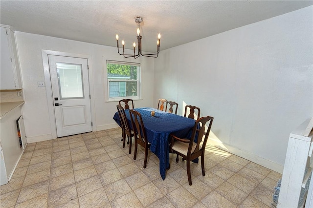 1309 Annapolis Dr, Corpus Christi, TX 78415 - dining area with a chandelier, baseboards, and a textured ceiling