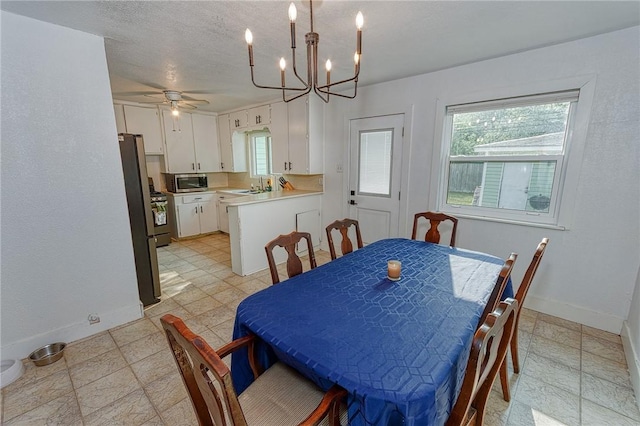1309 Annapolis Dr, Corpus Christi, TX 78415 - dining space featuring plenty of natural light, baseboards, a chandelier, ceiling fan, and a textured ceiling