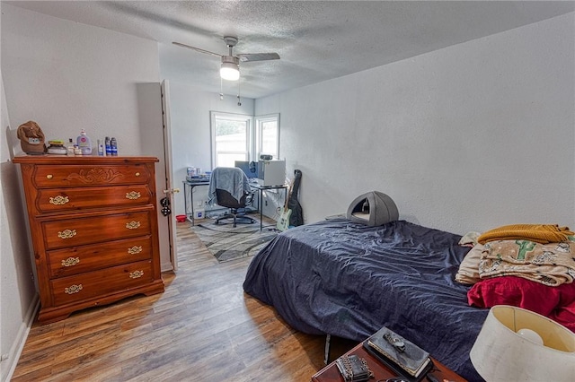 1309 Annapolis Dr, Corpus Christi, TX 78415 - bedroom with wood finished floors, a textured ceiling, a textured wall, and ceiling fan