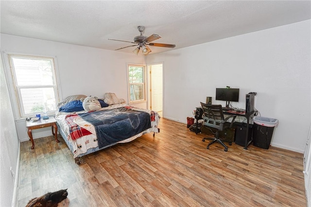1309 Annapolis Dr, Corpus Christi, TX 78415 - bedroom featuring light wood-type flooring, an office area, a ceiling fan, and baseboards