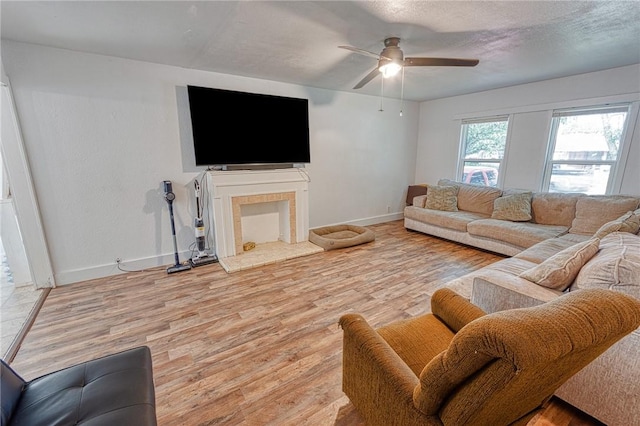 1309 Annapolis Dr, Corpus Christi, TX 78415 - living room featuring baseboards, a ceiling fan, light wood finished floors, and a textured ceiling