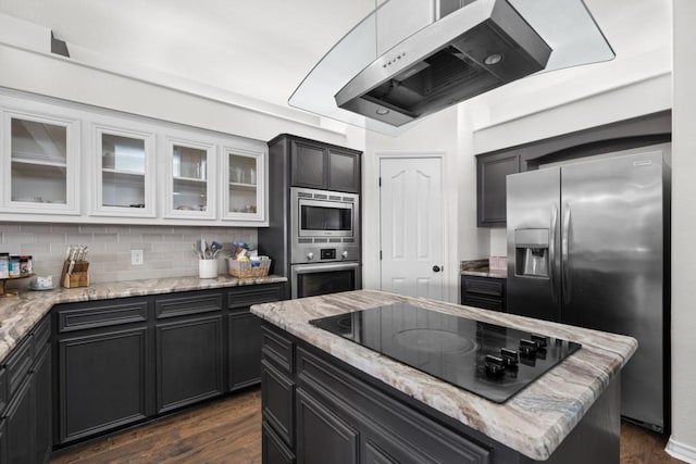 kitchen with stainless steel appliances, exhaust hood, glass insert cabinets, and white cabinetry