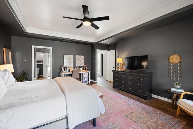 bedroom with dark wood-style floors, baseboards, a raised ceiling, and a ceiling fan