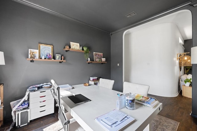 office area with dark wood-type flooring, visible vents, and crown molding