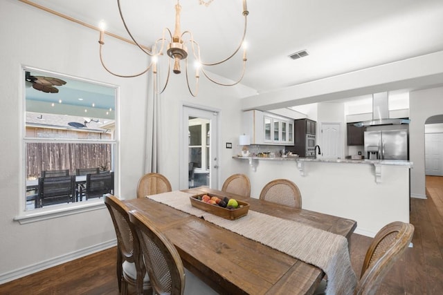 dining area with an inviting chandelier, baseboards, visible vents, and dark wood-style flooring