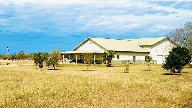 back of property featuring a lawn