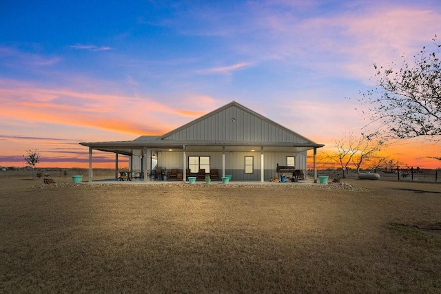 back house at dusk with a patio