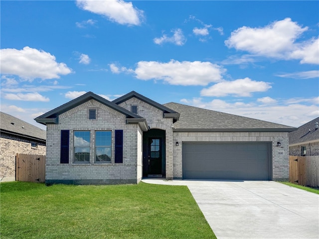 view of front of house with a front yard and a garage