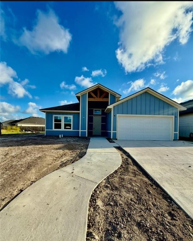 6721 La Salle Dr, Corpus Christi, TX 78414 - view of front of house with a garage, driveway, and board and batten siding