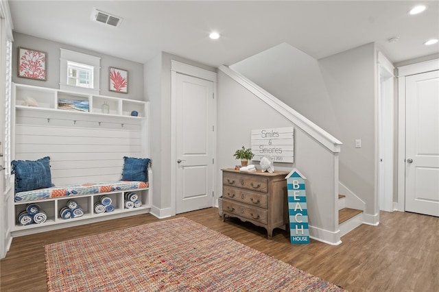 mudroom with recessed lighting, wood finished floors, visible vents, and baseboards