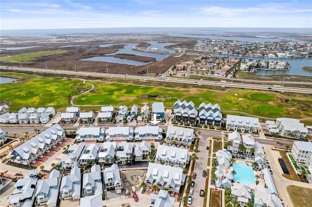 aerial view with golf course view and a water view