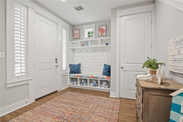 mudroom featuring wood finished floors, visible vents, and baseboards