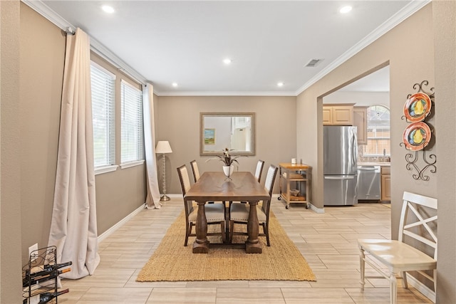 4658 Oso Pkwy, Corpus Christi, TX 78413 - dining space featuring healthy amount of natural light, crown molding, recessed lighting, and wood tiled floors