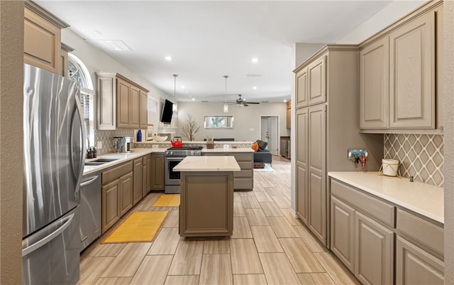 4658 Oso Pkwy, Corpus Christi, TX 78413 - kitchen featuring stainless steel appliances, a peninsula, recessed lighting, decorative backsplash, and a center island