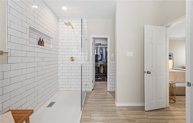 4658 Oso Pkwy, Corpus Christi, TX 78413 - ensuite bathroom featuring a stall shower, wood finished floors, a spacious closet, and recessed lighting