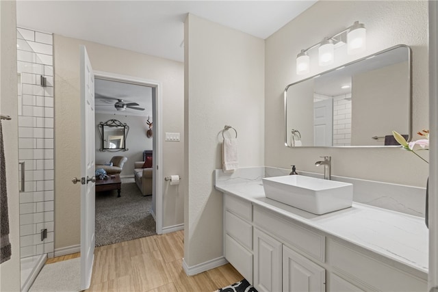 4658 Oso Pkwy, Corpus Christi, TX 78413 - ensuite bathroom featuring wood finished floors, vanity, ceiling fan, and a tile shower