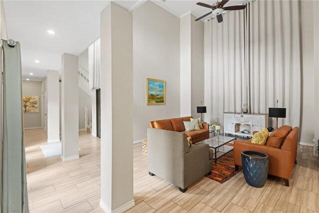 4658 Oso Pkwy, Corpus Christi, TX 78413 - living room featuring ceiling fan, wood finish floors, crown molding, recessed lighting, and a towering ceiling