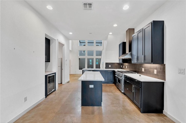 kitchen with backsplash, ventilation hood, high end stainless steel range oven, beverage cooler, and a center island