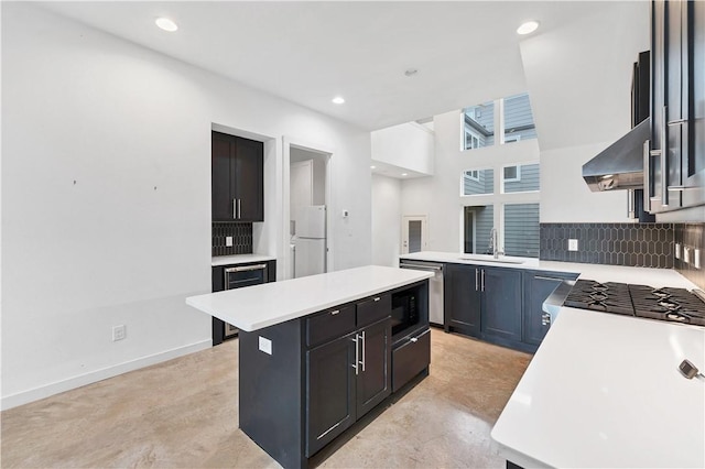 kitchen with appliances with stainless steel finishes, ventilation hood, a kitchen island, sink, and wine cooler