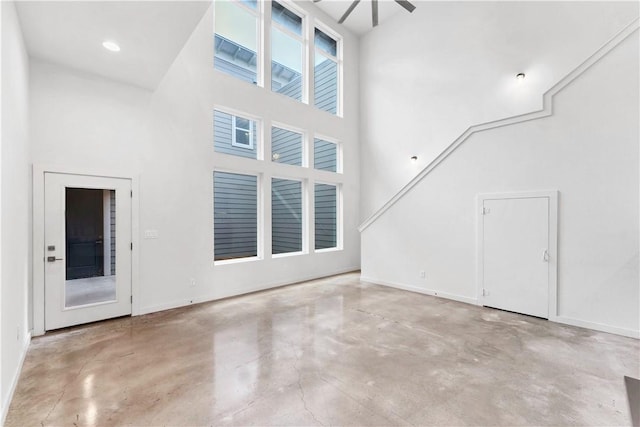 unfurnished living room with a towering ceiling