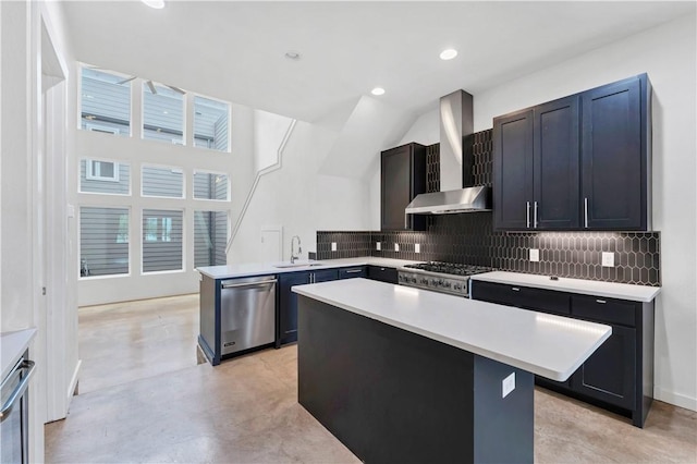 kitchen with stainless steel dishwasher, sink, wall chimney range hood, range, and a kitchen island