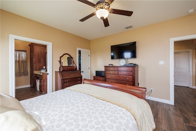 bedroom with ceiling fan, dark hardwood / wood-style floors, and ensuite bath