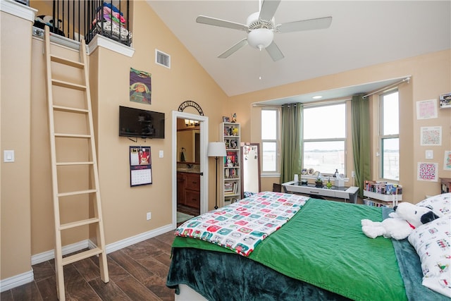 bedroom with dark hardwood / wood-style floors, ensuite bath, ceiling fan, and lofted ceiling