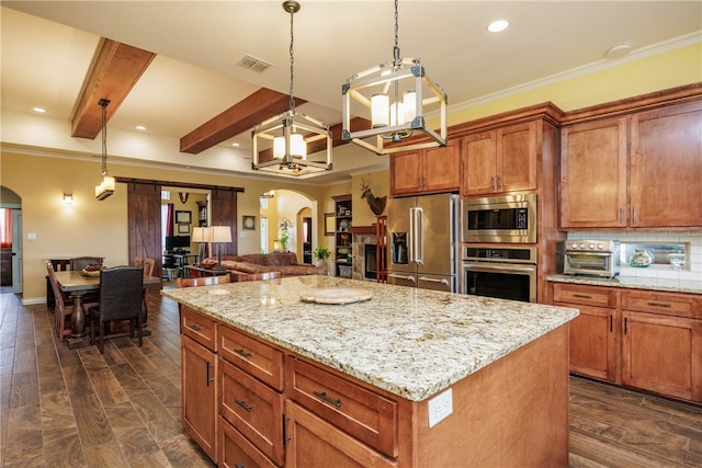 kitchen featuring hanging light fixtures, dark wood-type flooring, beamed ceiling, a kitchen island, and appliances with stainless steel finishes