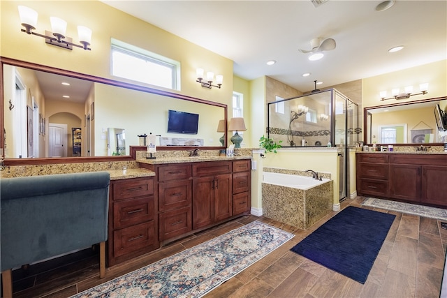 bathroom featuring vanity, plus walk in shower, and hardwood / wood-style flooring