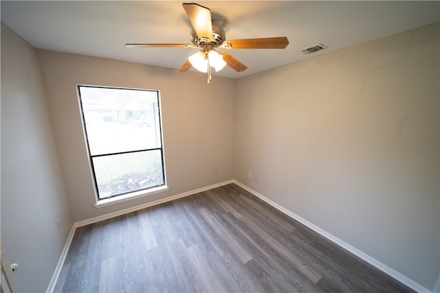 unfurnished room with ceiling fan and dark hardwood / wood-style floors