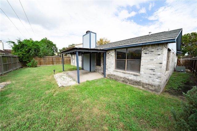 rear view of property with a patio, a lawn, and cooling unit