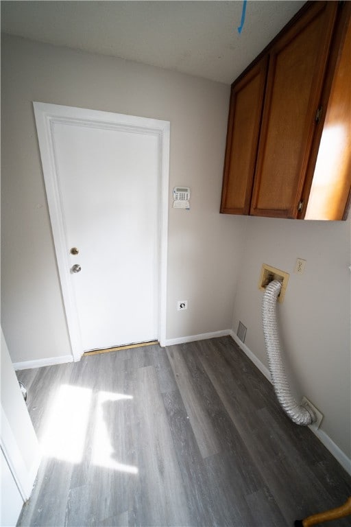 laundry area featuring cabinets and wood-type flooring