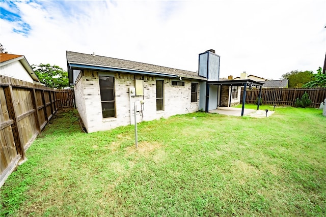 back of property featuring a lawn and a patio