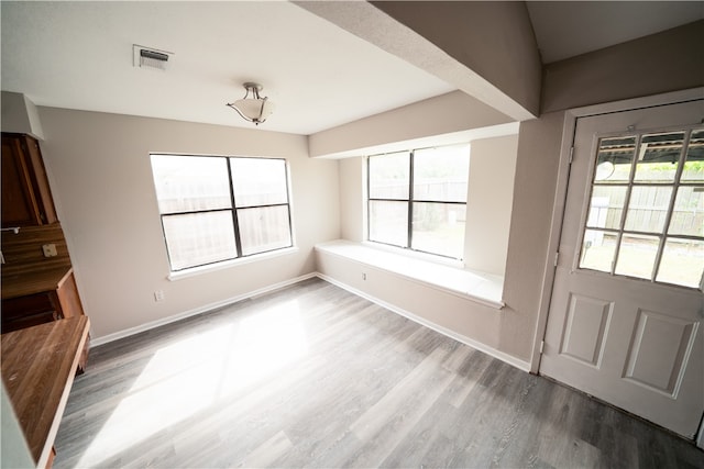 unfurnished dining area with wood-type flooring