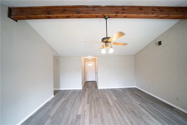 spare room with hardwood / wood-style floors, ceiling fan, and vaulted ceiling with beams