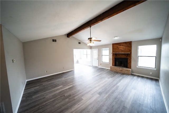 unfurnished living room with dark hardwood / wood-style flooring, ceiling fan, lofted ceiling with beams, and a brick fireplace