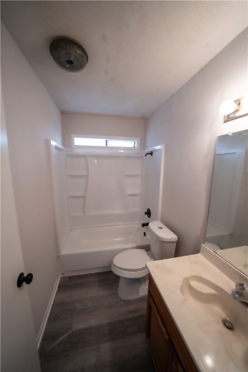 full bathroom featuring toilet, wood-type flooring, washtub / shower combination, and vanity