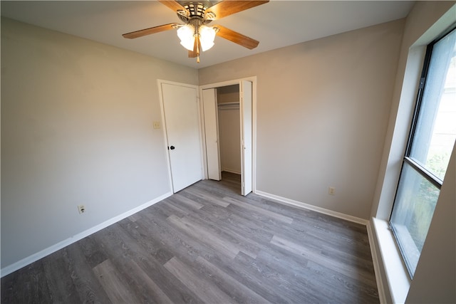 unfurnished bedroom featuring dark hardwood / wood-style flooring, a closet, and ceiling fan