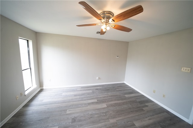 unfurnished room featuring dark hardwood / wood-style flooring and ceiling fan