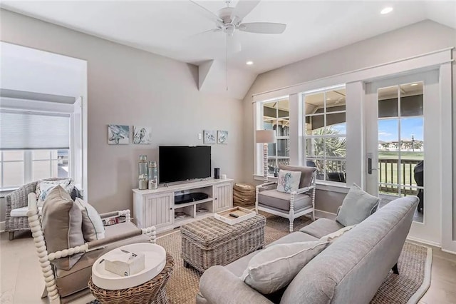 living room featuring vaulted ceiling, wood-type flooring, and ceiling fan