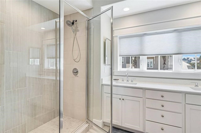 bathroom featuring vanity and a shower with shower door