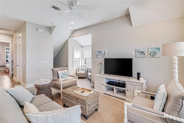 living room with light hardwood / wood-style flooring, vaulted ceiling, and ceiling fan