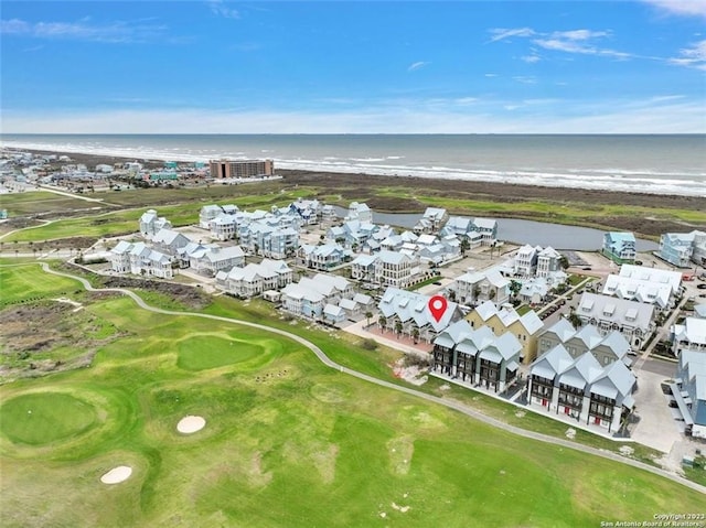 bird's eye view featuring a water view and a beach view