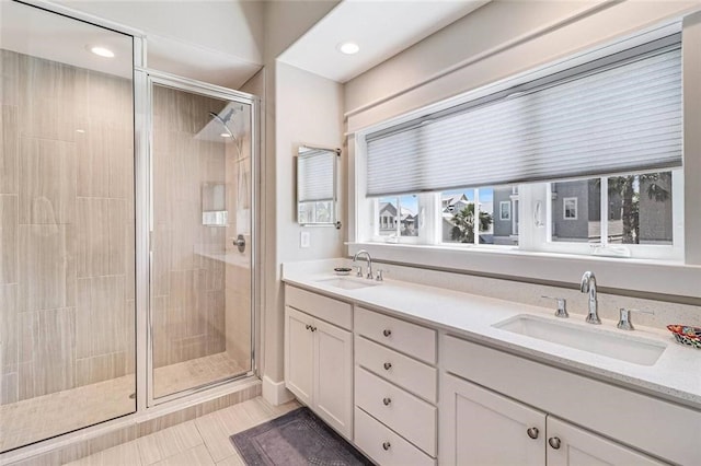 bathroom featuring vanity, tile patterned flooring, and walk in shower